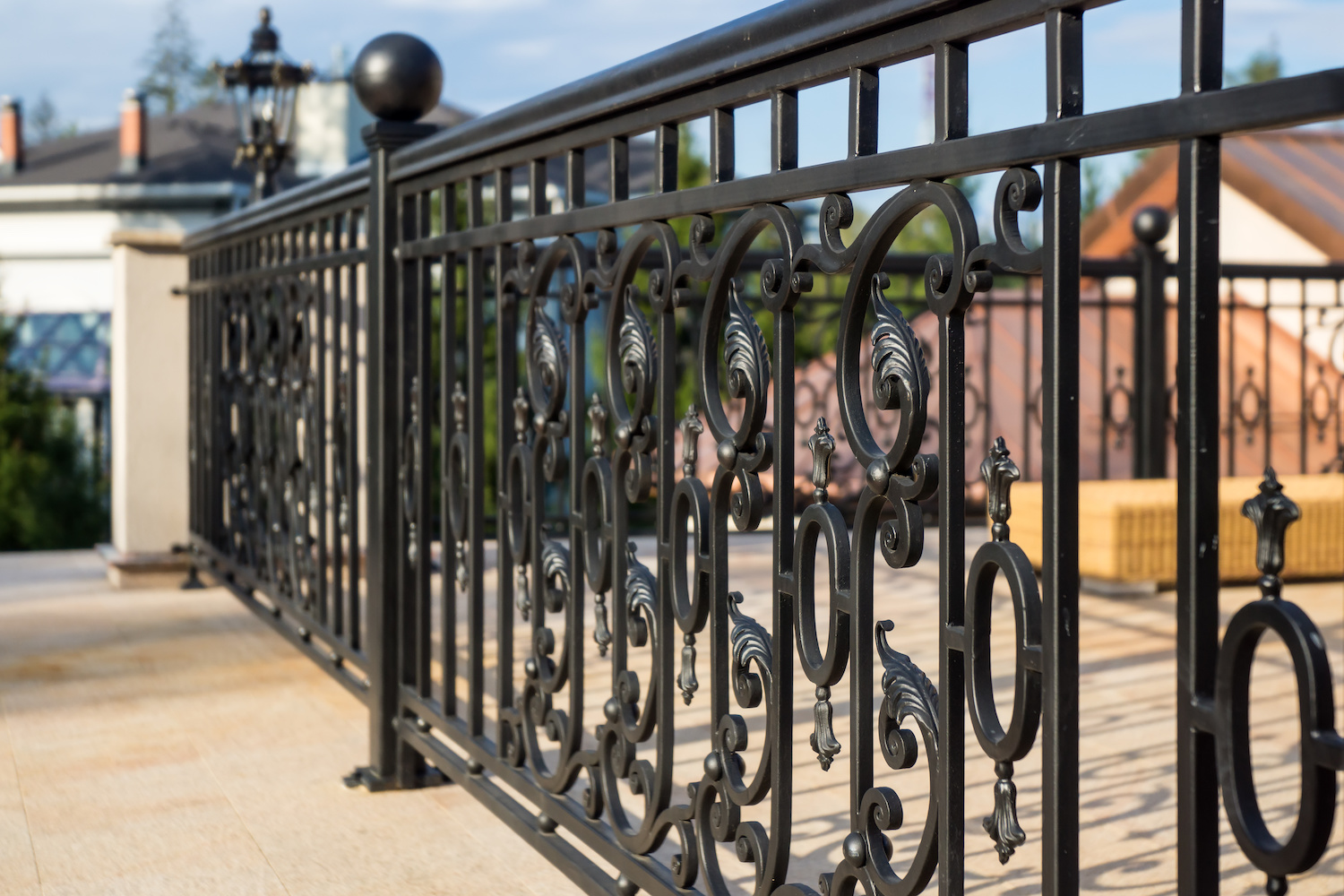 Ornamental black fence installation by Fortitude Fencing highlights the property's aesthetic appeal and security.